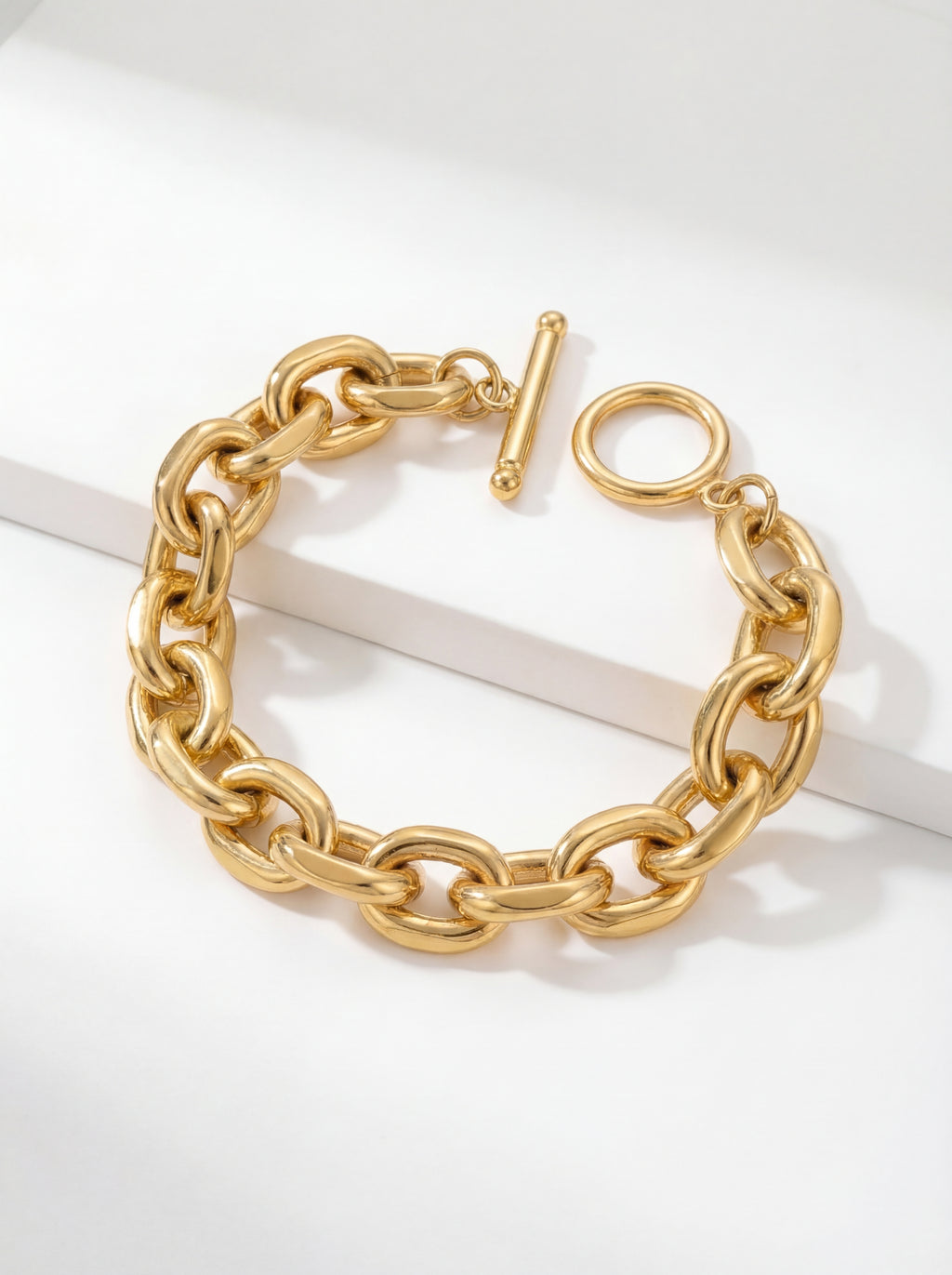 Gold chain bracelet on a white background