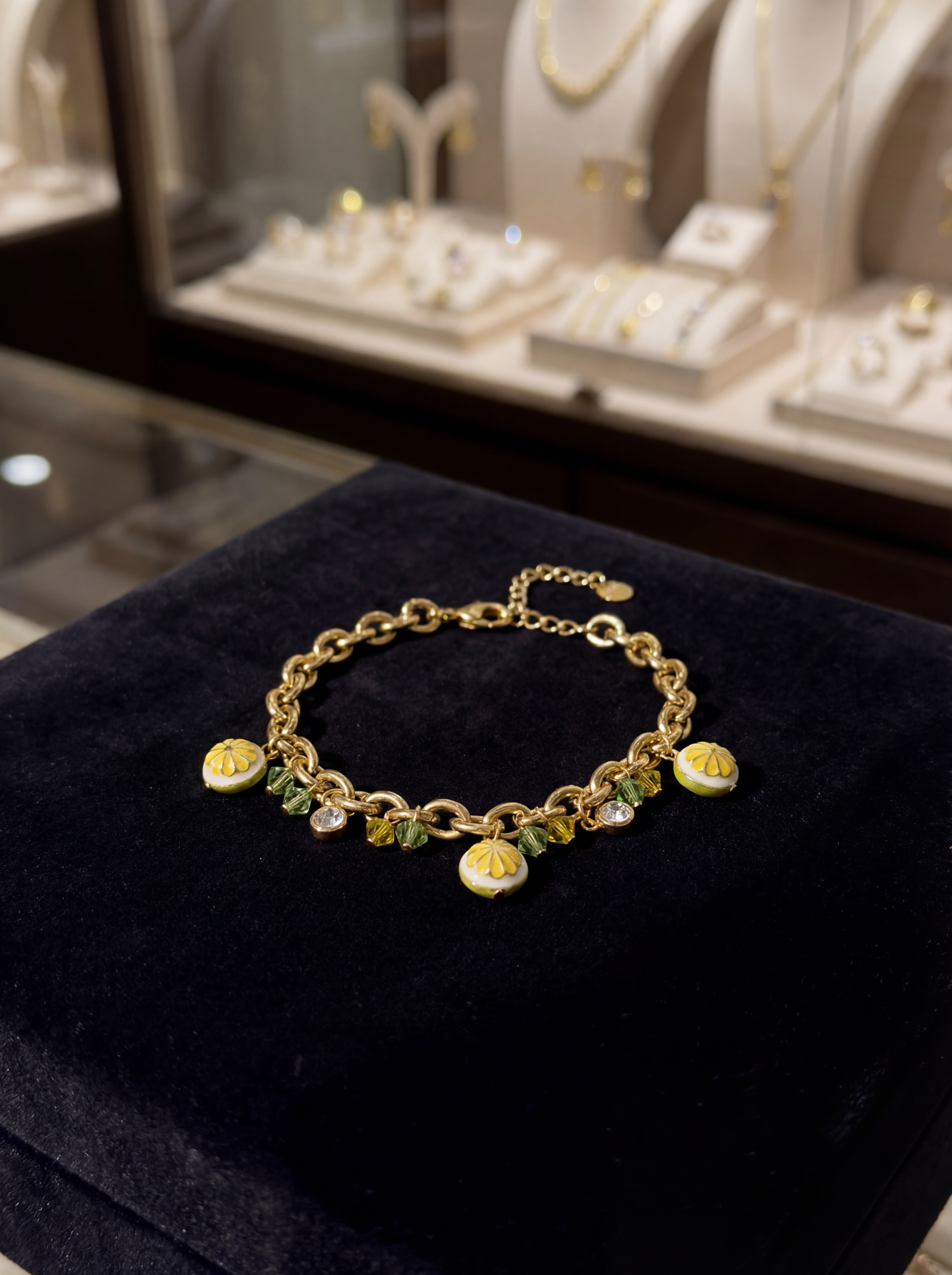 Gold bracelet with charm on a black surface, jewelry store background