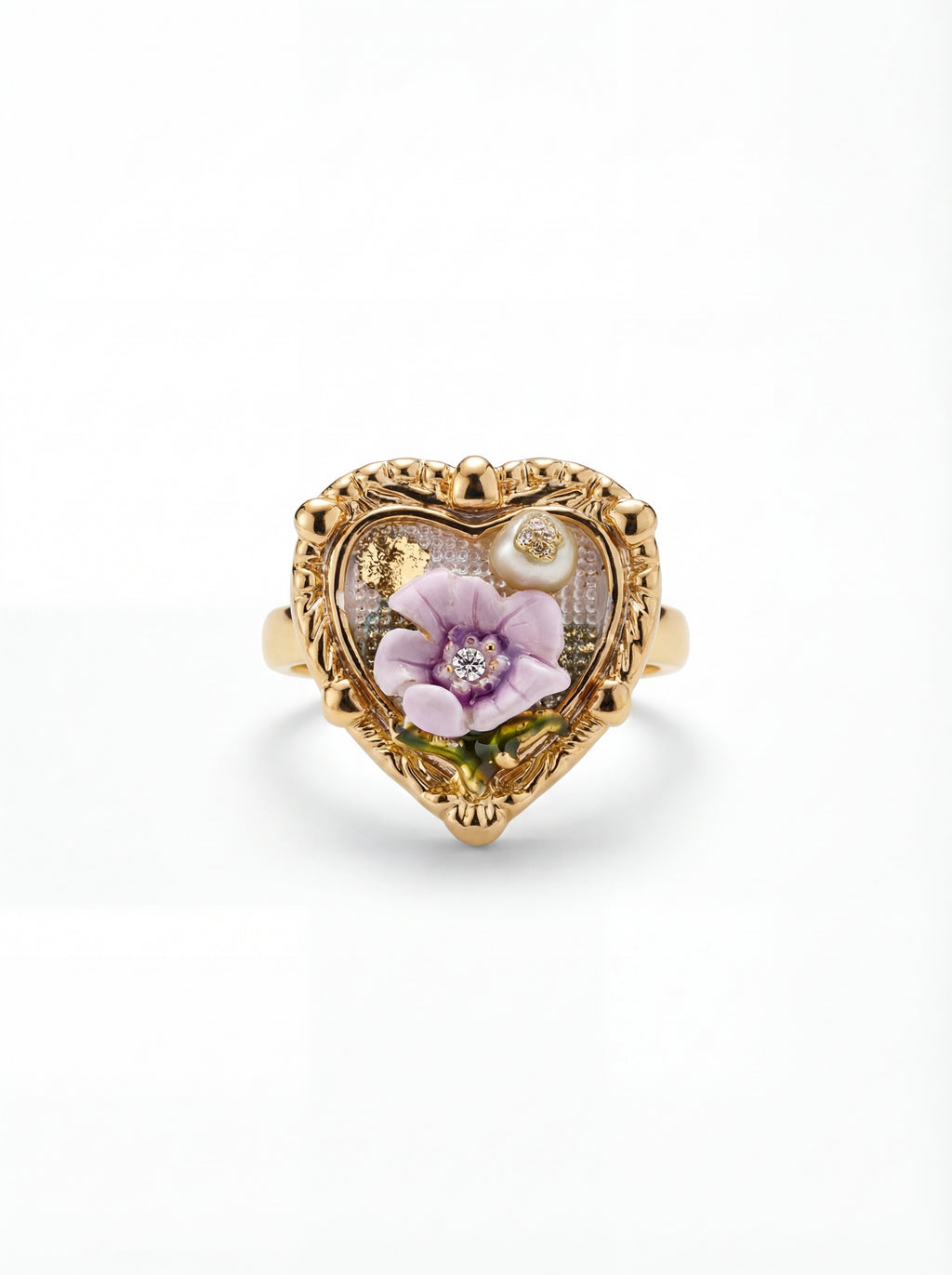 Heart-shaped gold ring with floral design on a white background
