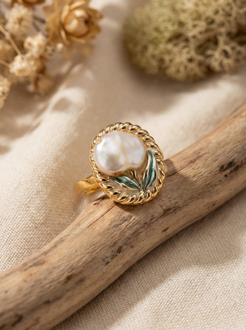 Gold ring with a pearl on a natural background