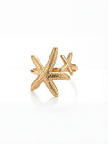 Gold starfish-shaped ring on a white background