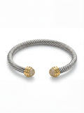 Silver bracelet with gold accents on a white background