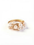 Gold ring with pearls on a white background