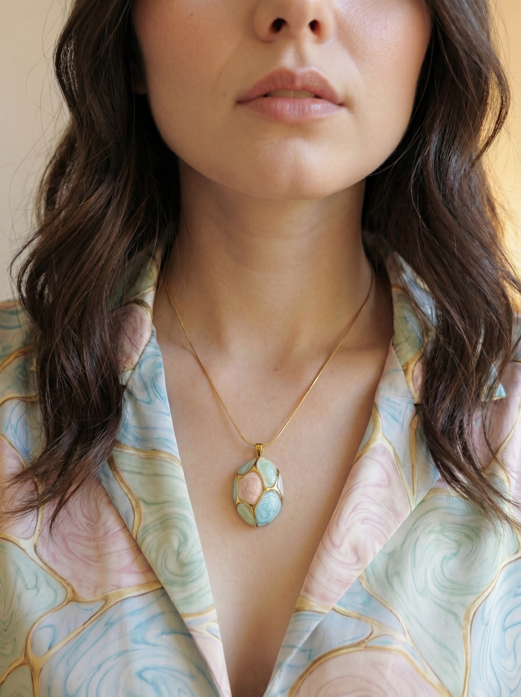 Close-up of a woman wearing a necklace with a floral pendant.