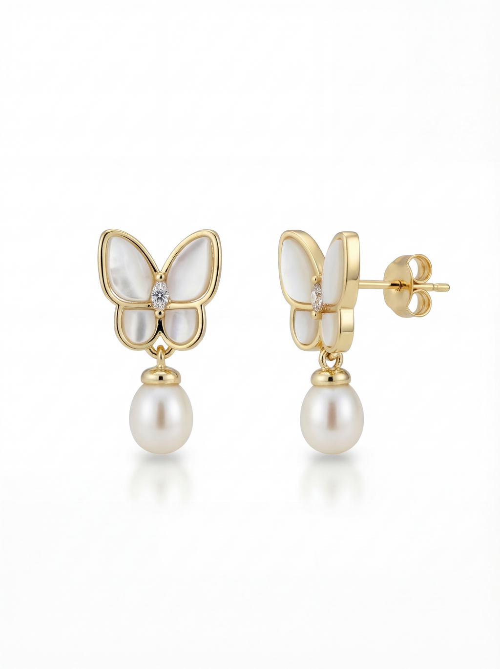 Butterfly-shaped earrings with pearl drops on a white background