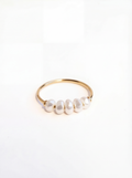 Gold ring with pearls on a white background