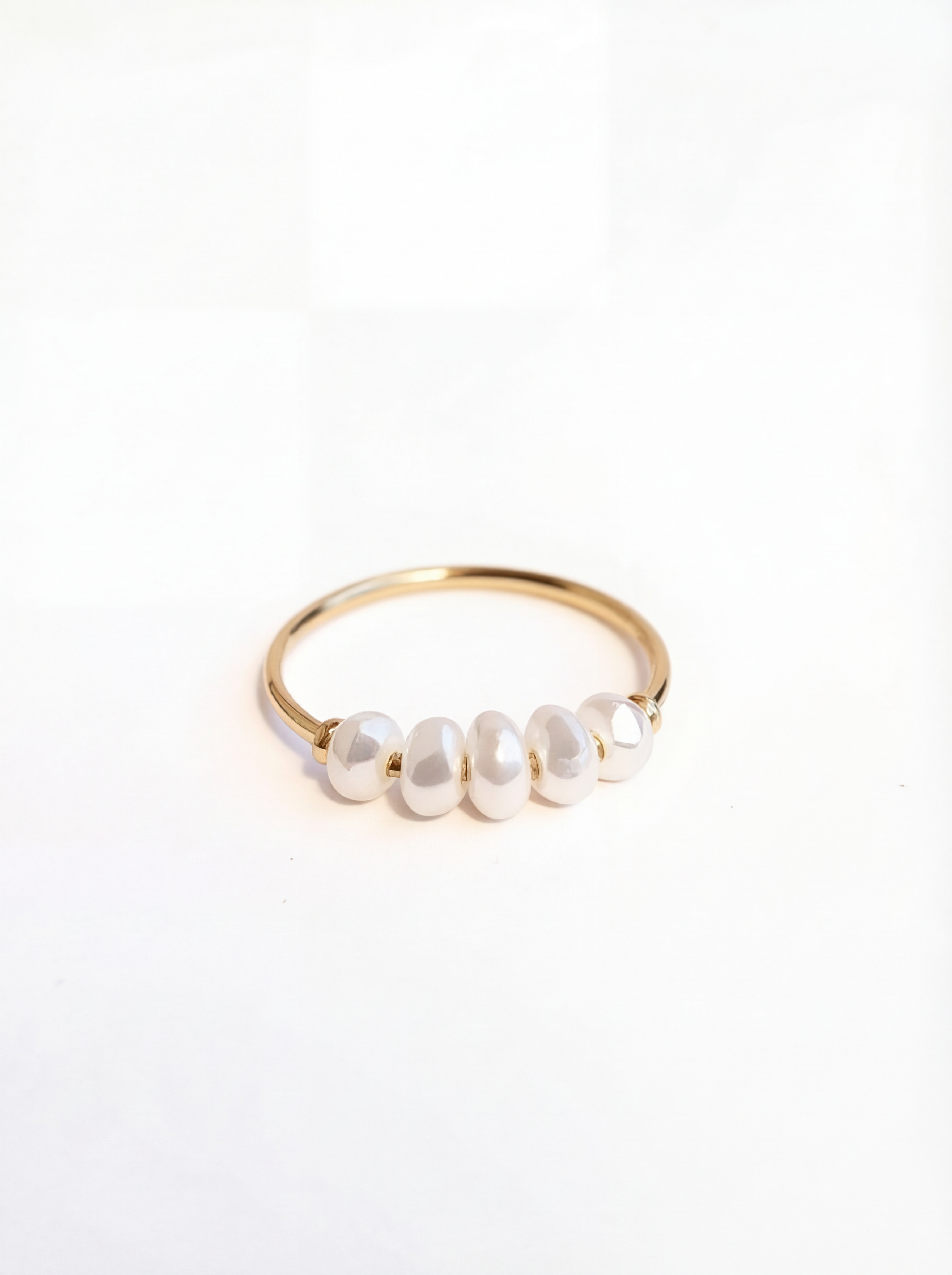 Gold ring with pearls on a white background