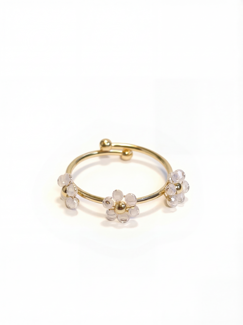 Gold ring with floral designs on a white background