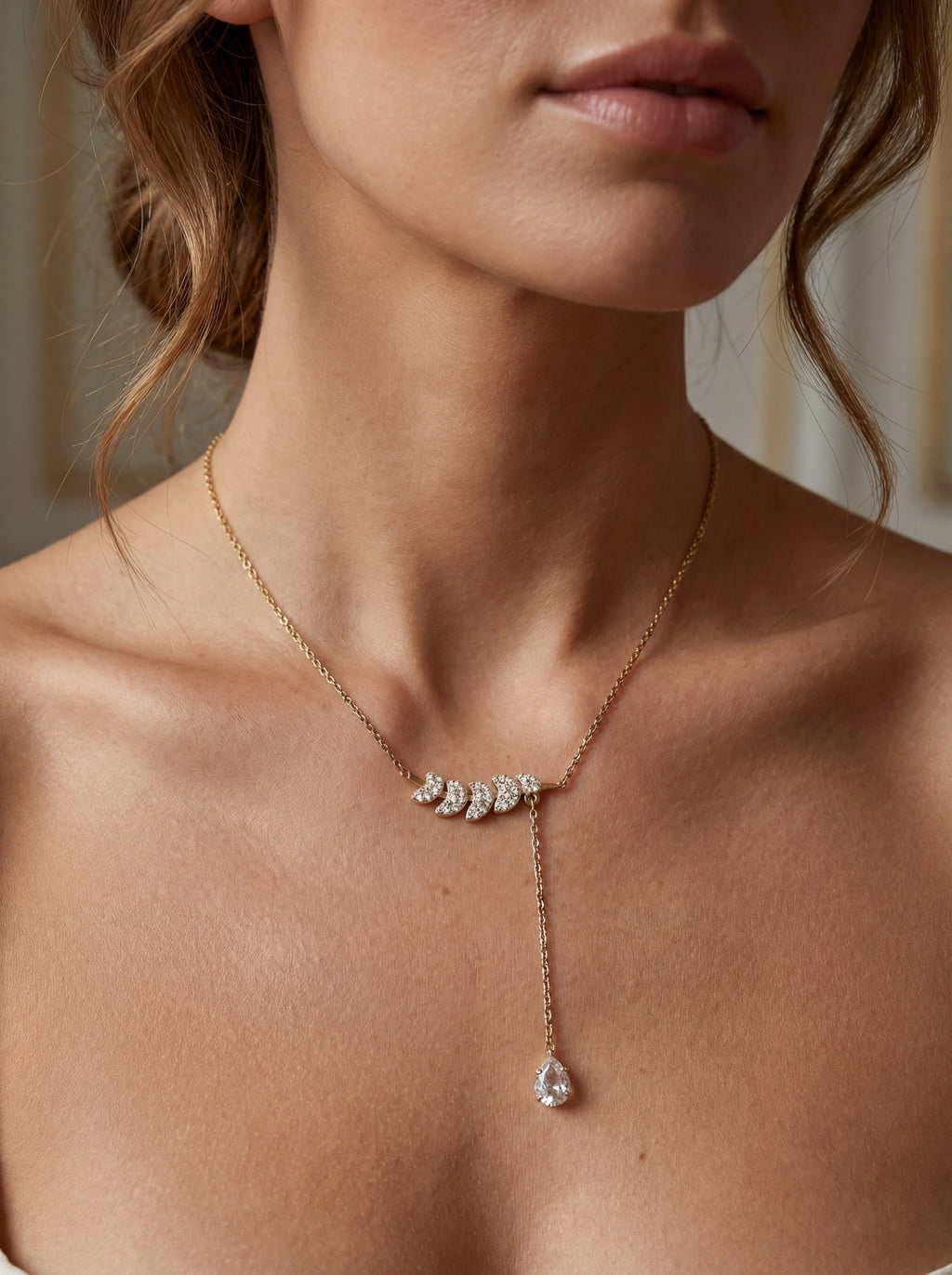 Close-up of a necklace with a pendant on a person's neck.