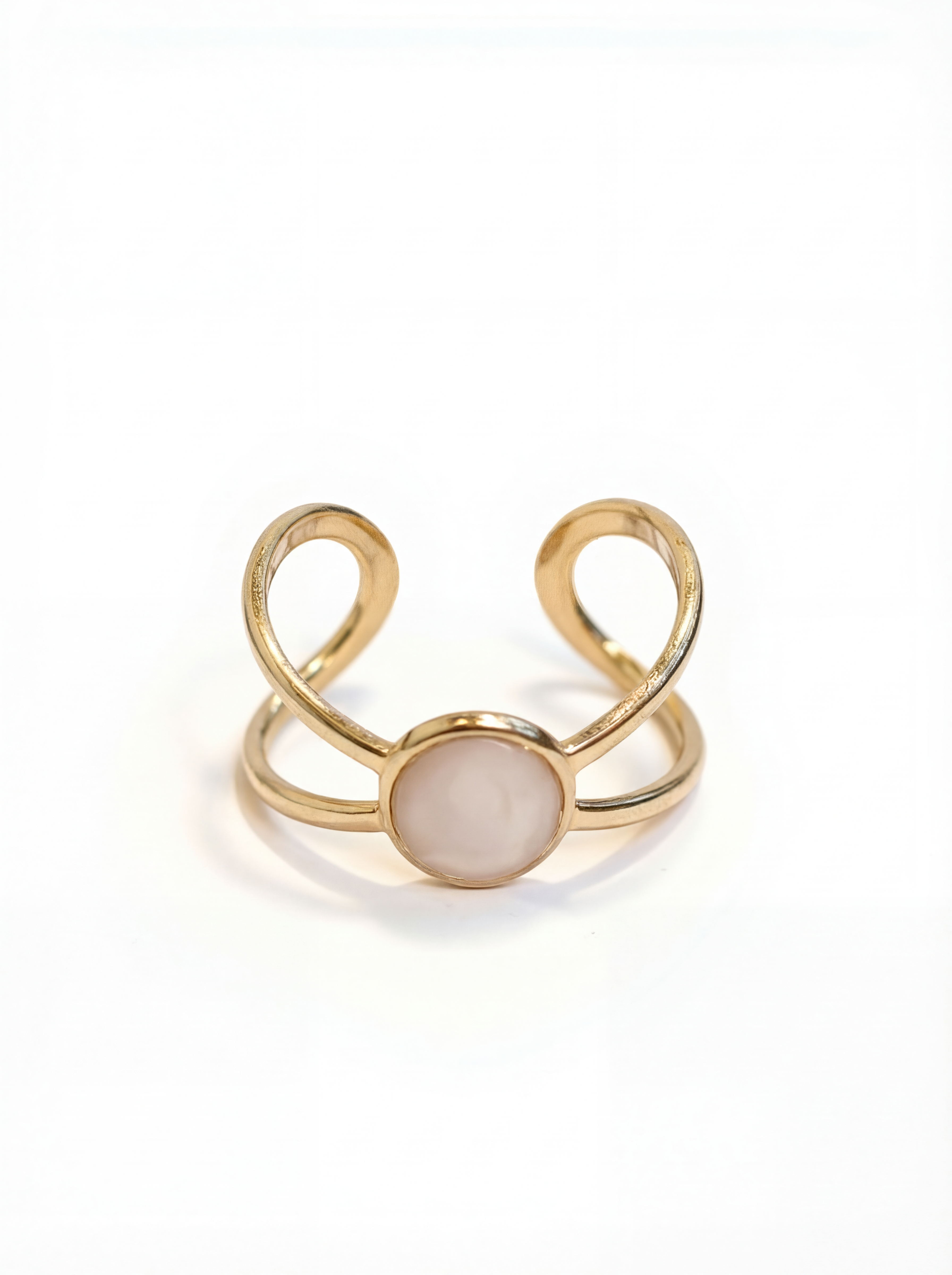 Gold ring with a central gemstone on a white background