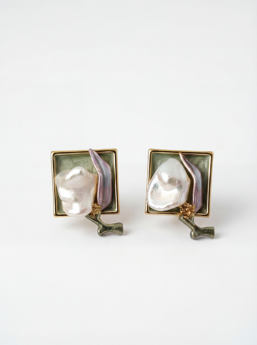 Pair of earrings with pearl-like centers on a white background