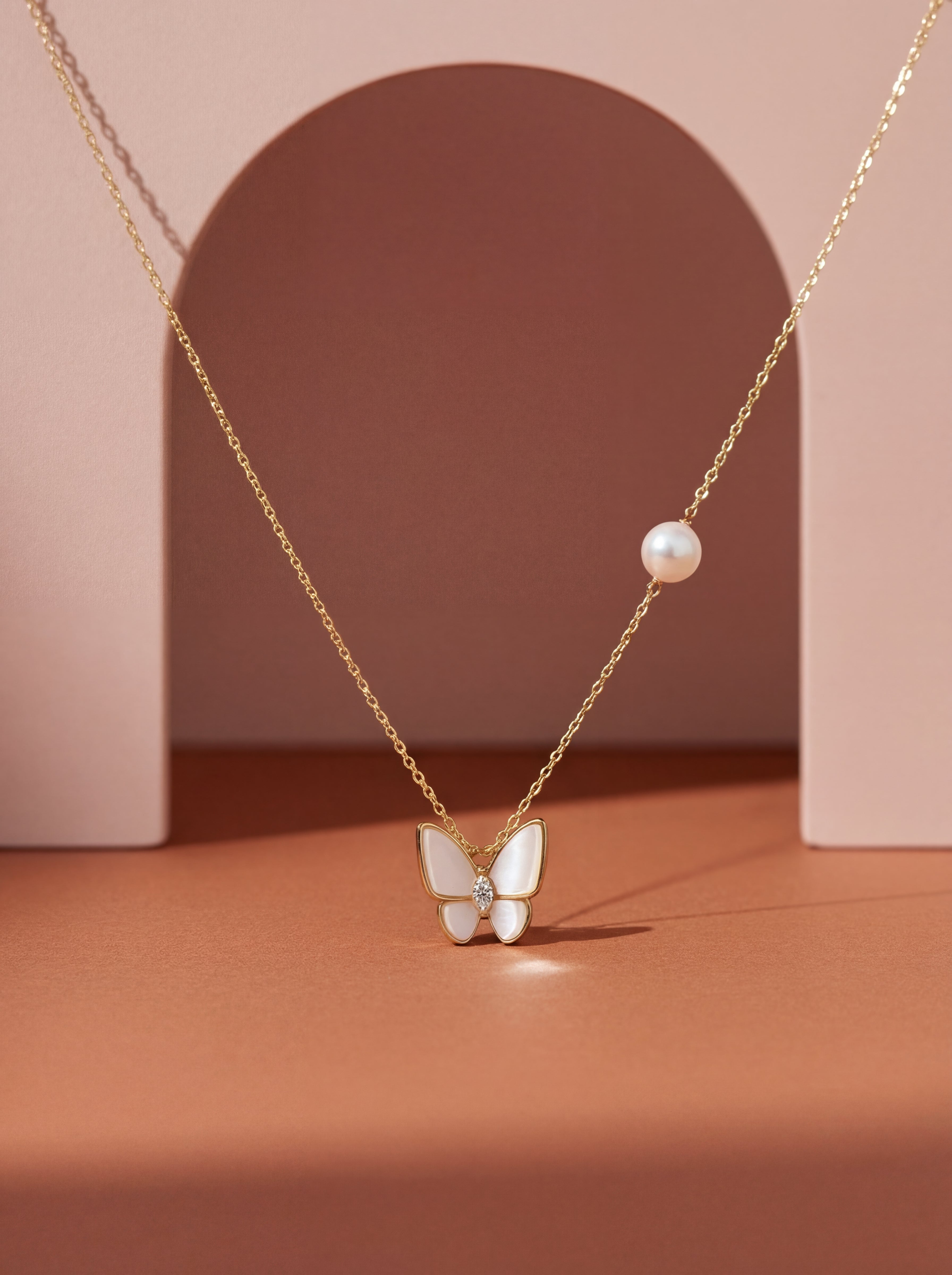 Necklace with a butterfly pendant and pearl on a pink background