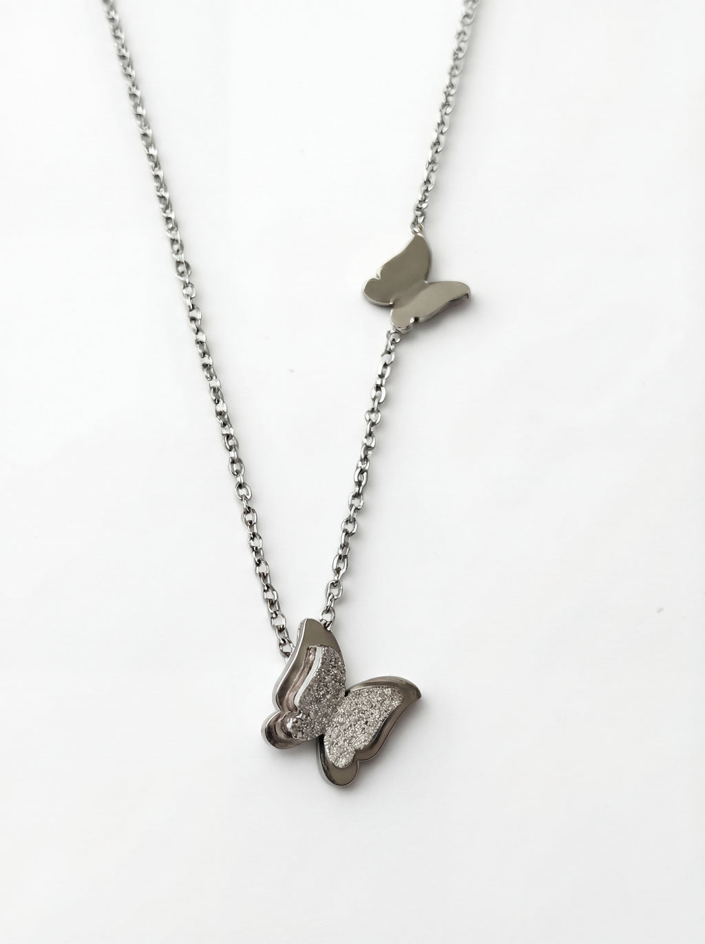 Butterfly-shaped pendant necklace on a white background