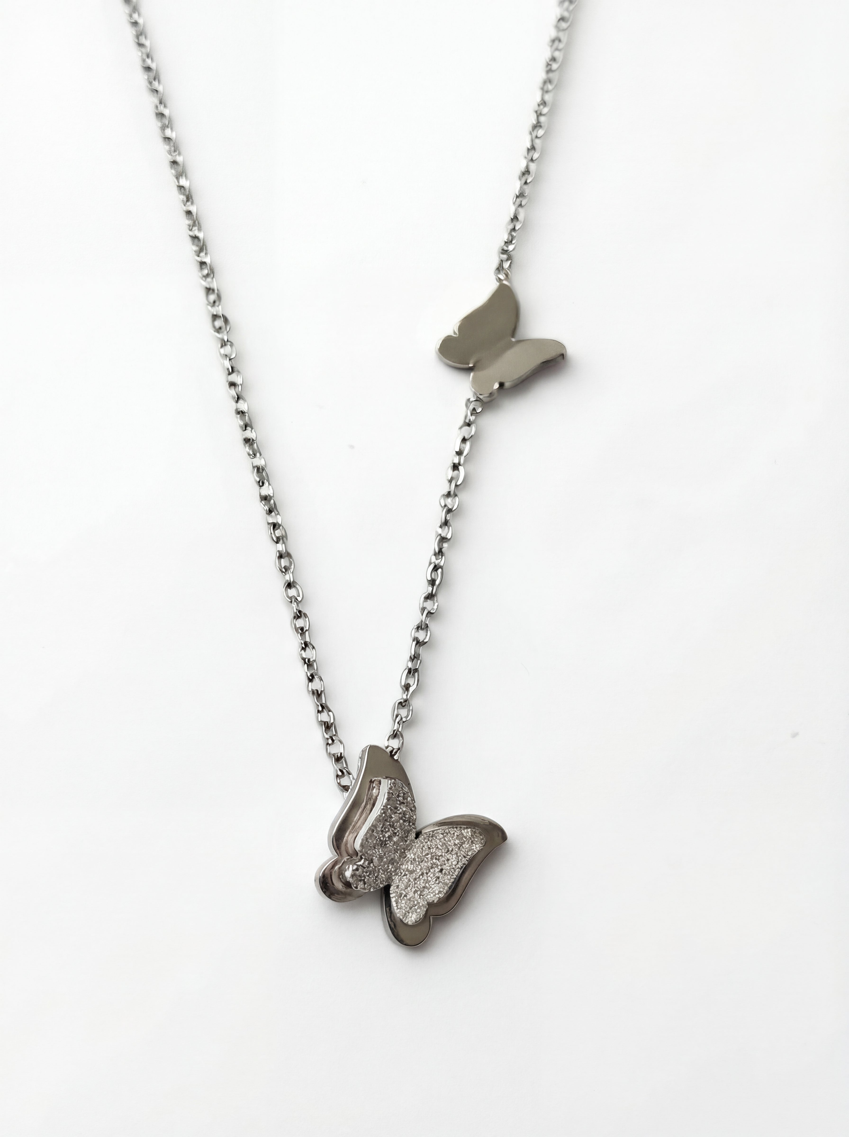 Butterfly-shaped pendant necklace on a white background