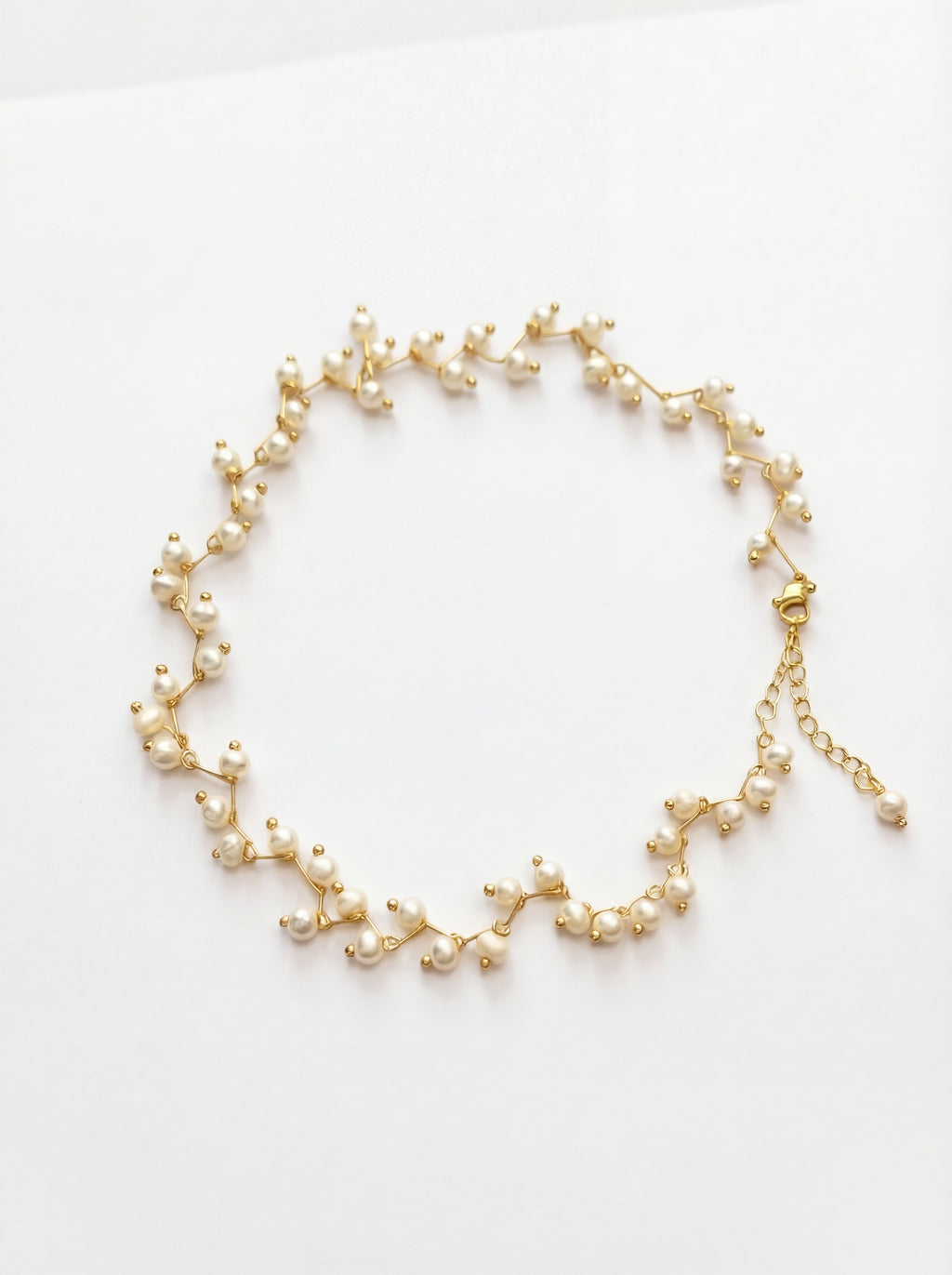 Delicate pearl necklace on a white background