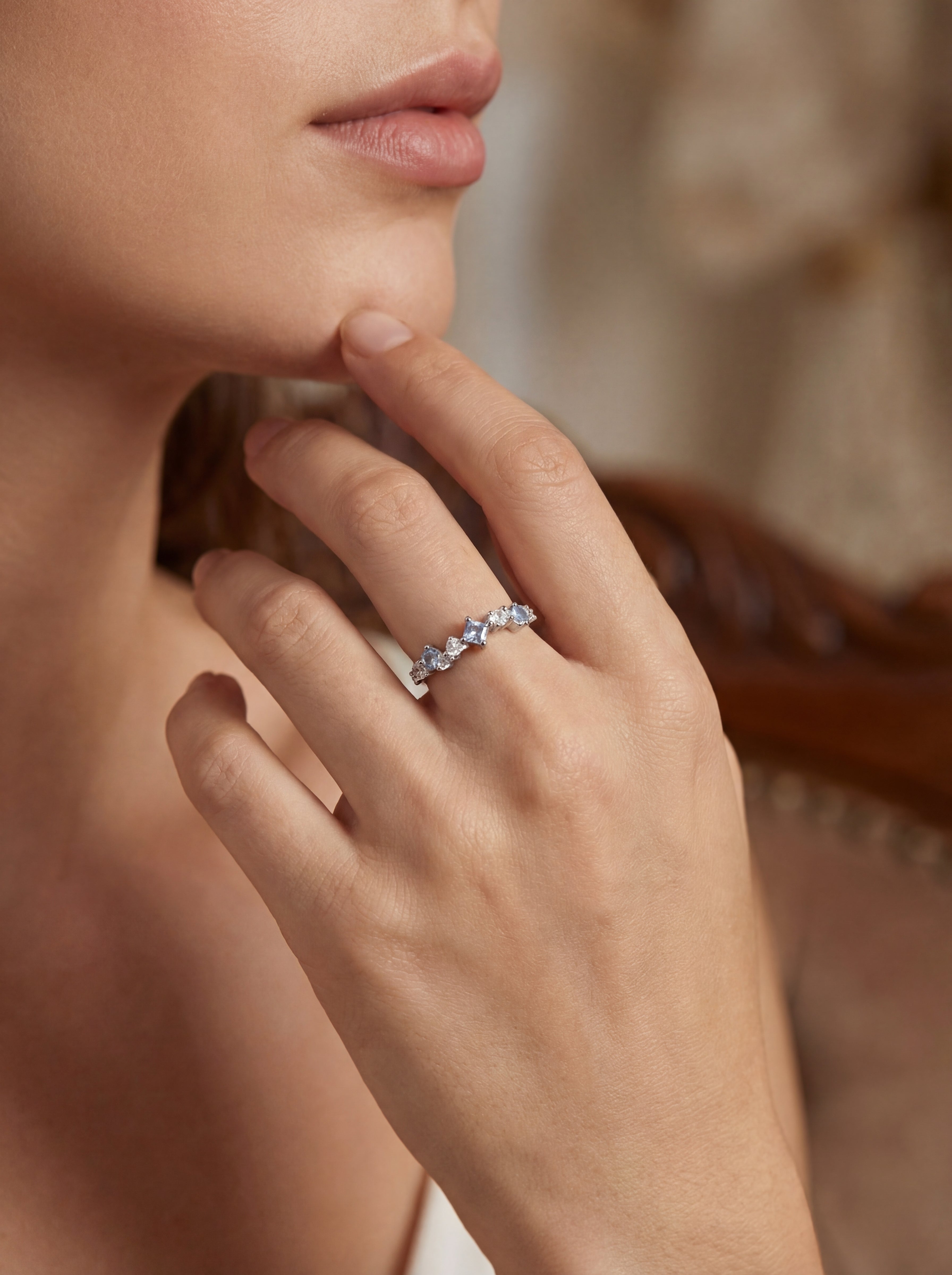 Close-up of a hand wearing a ring with a blurred background