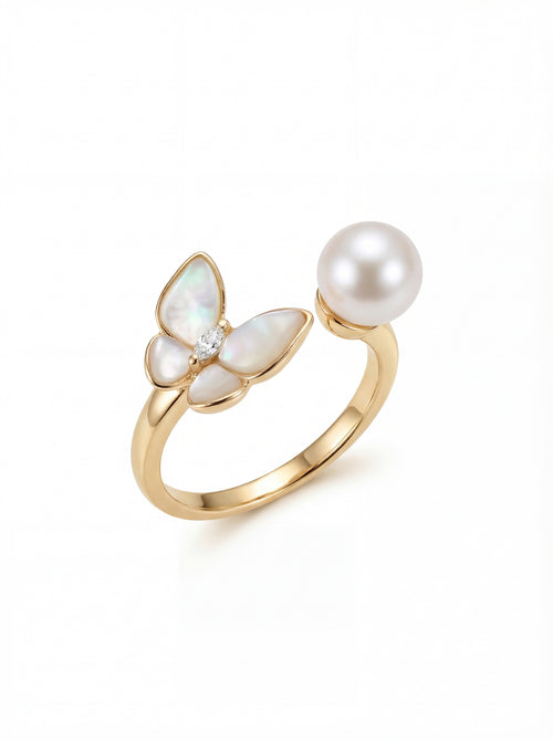 Gold ring with butterfly-shaped opals and a pearl on a white background