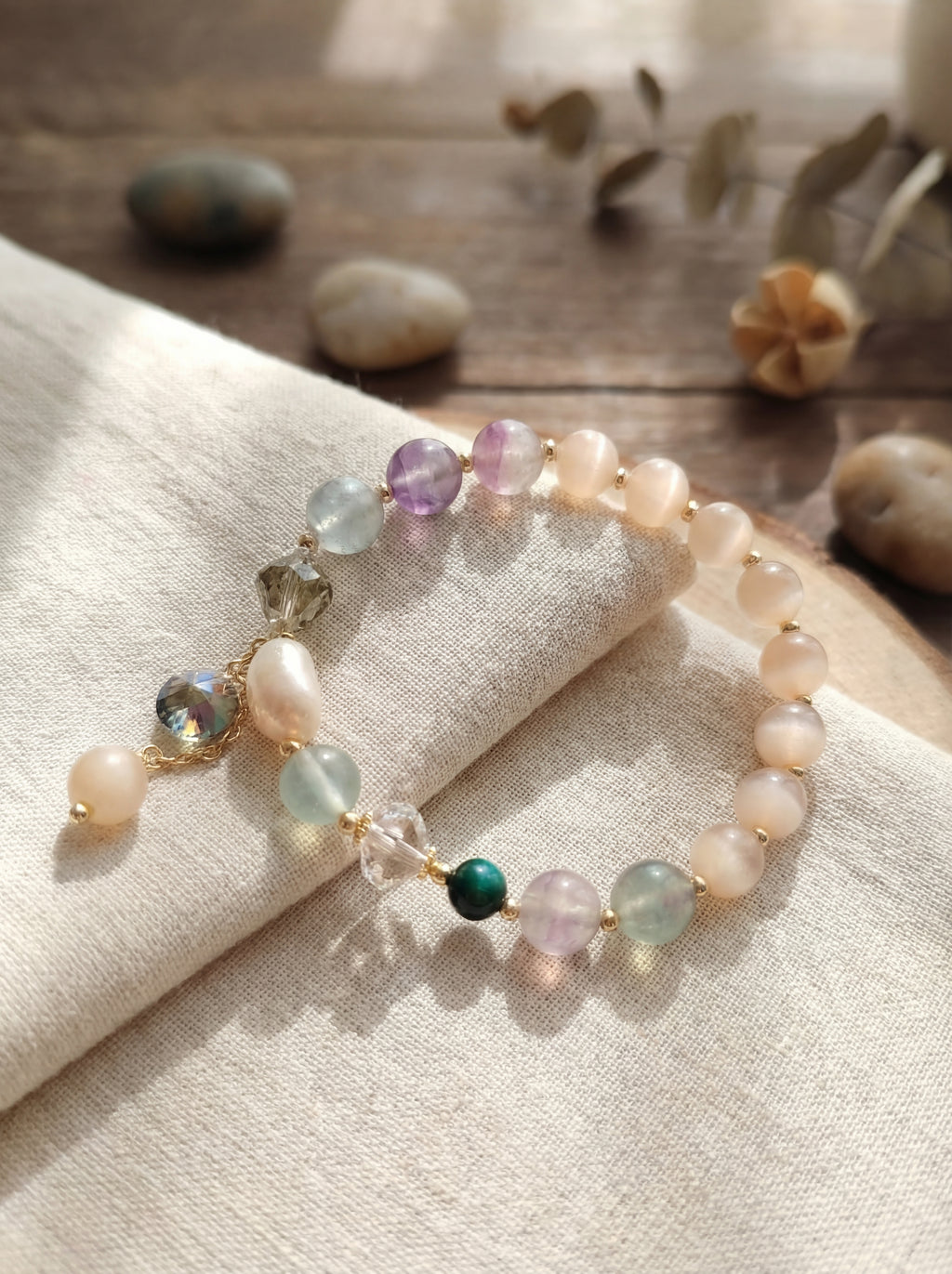 Beaded bracelet with multicolored beads on a textured fabric surface