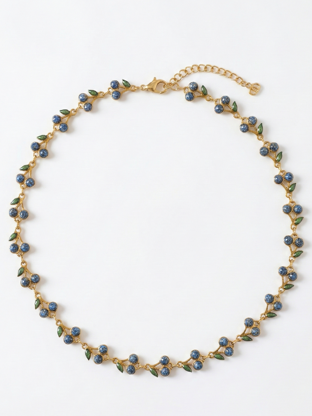 Gold necklace with blue and green beads on a white background