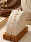 Pearl bracelet with gold accents on a wooden stand with a neutral background