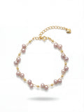 Pearl bracelet with gold accents on a white background
