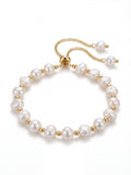 Pearl bracelet with gold accents on a white background