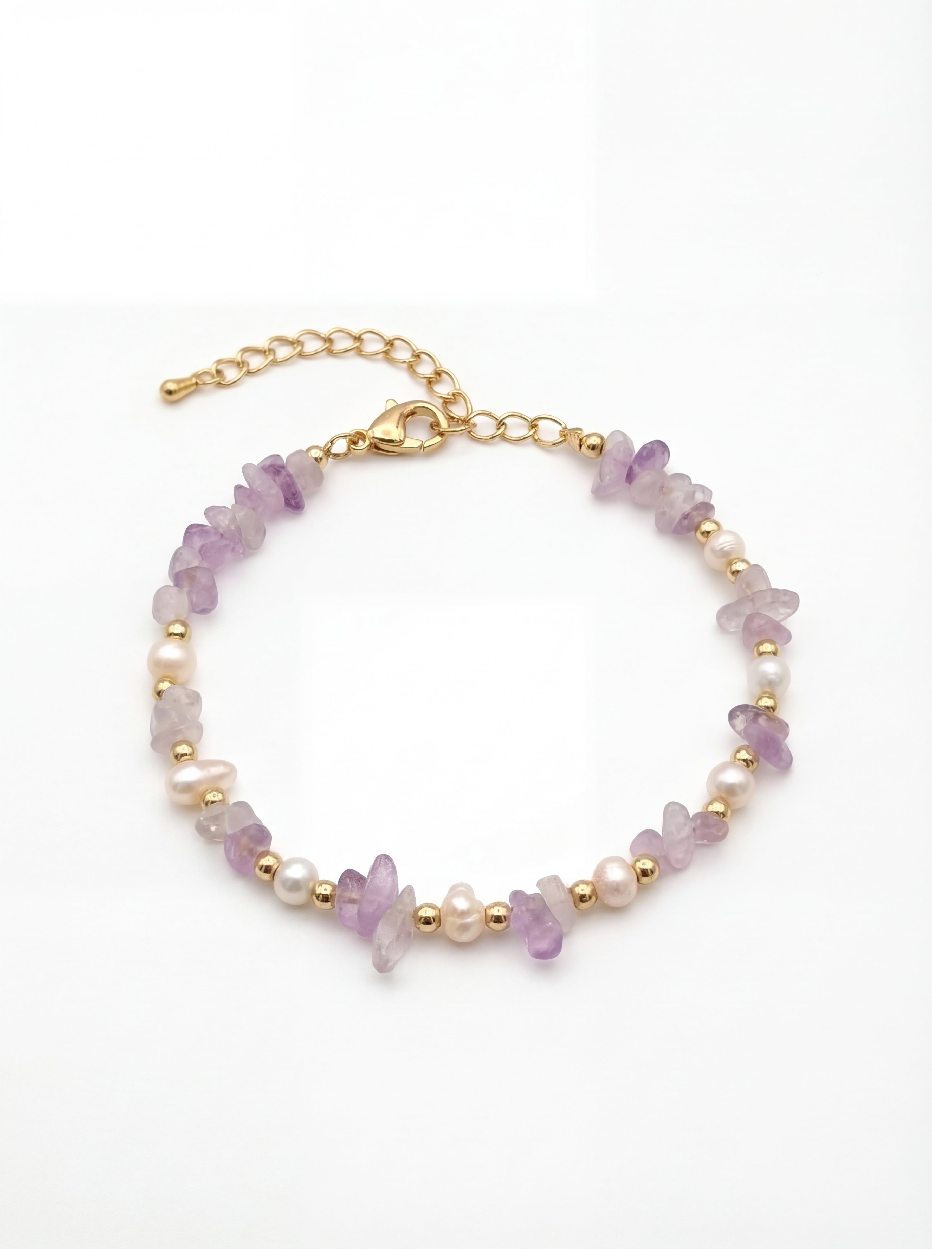Bracelet with purple and gold beads on a white background