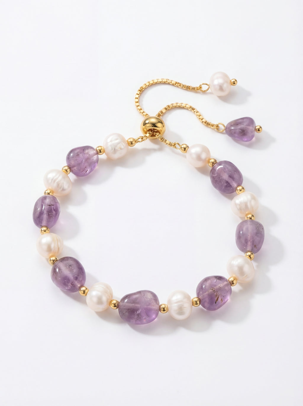 Bracelet with purple beads and pearls on a white background
