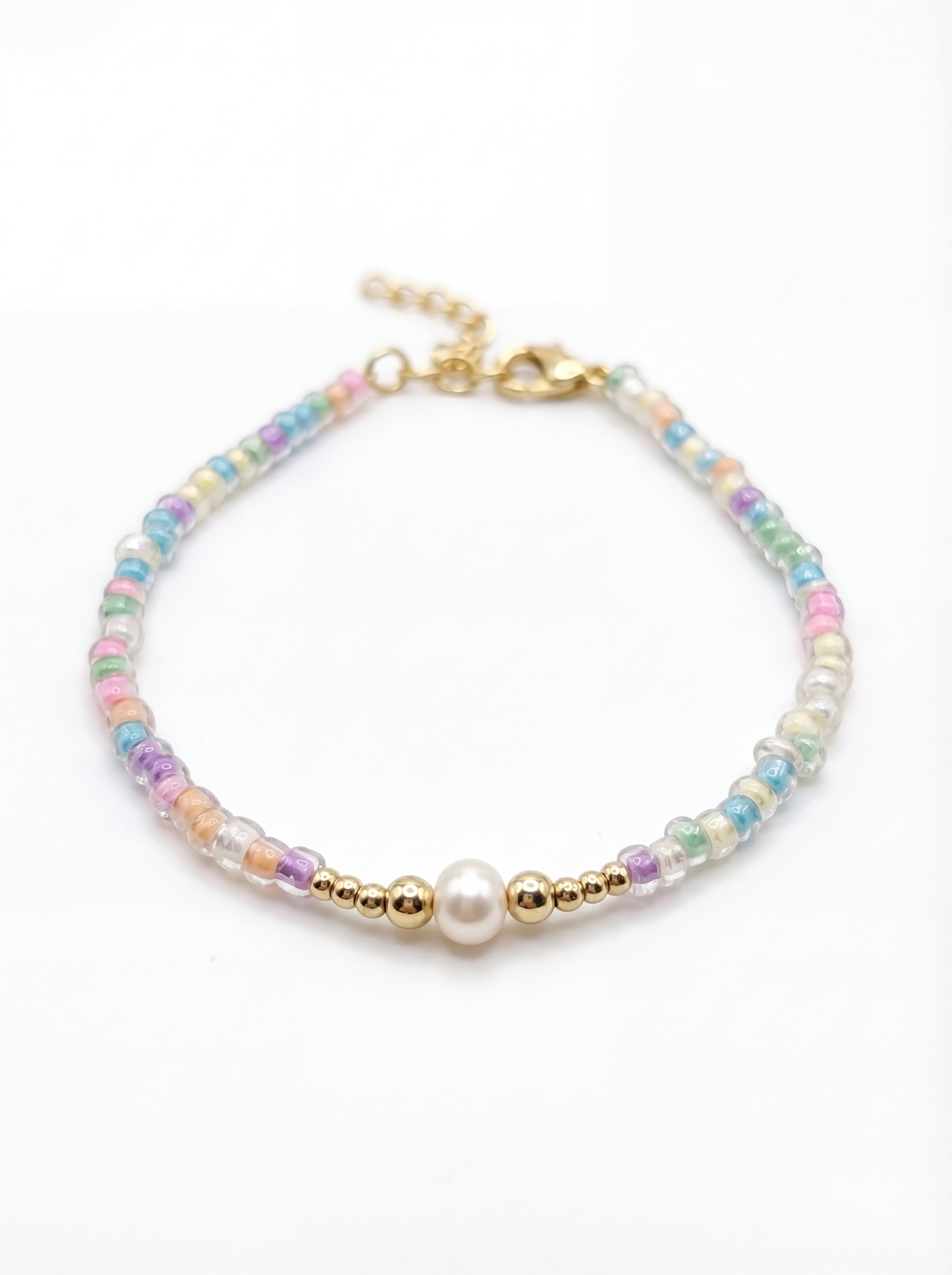 Multicolored beaded bracelet with a gold clasp on a white background