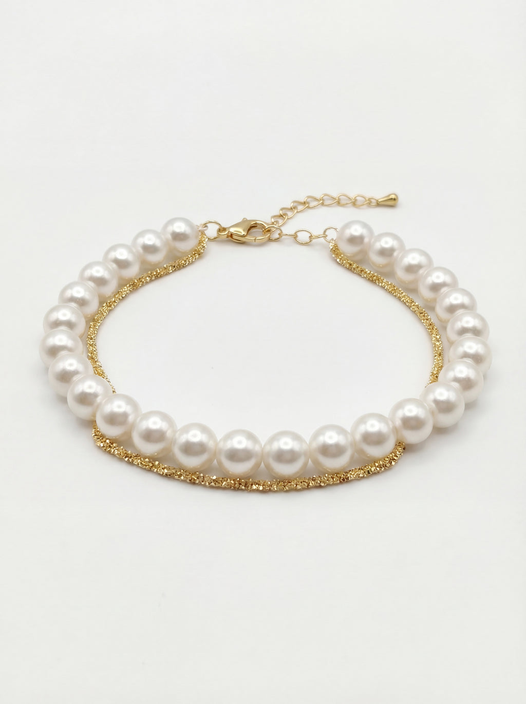 Pearl bracelet with gold chain on a white background