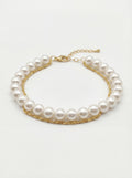 Pearl bracelet with gold chain on a white background