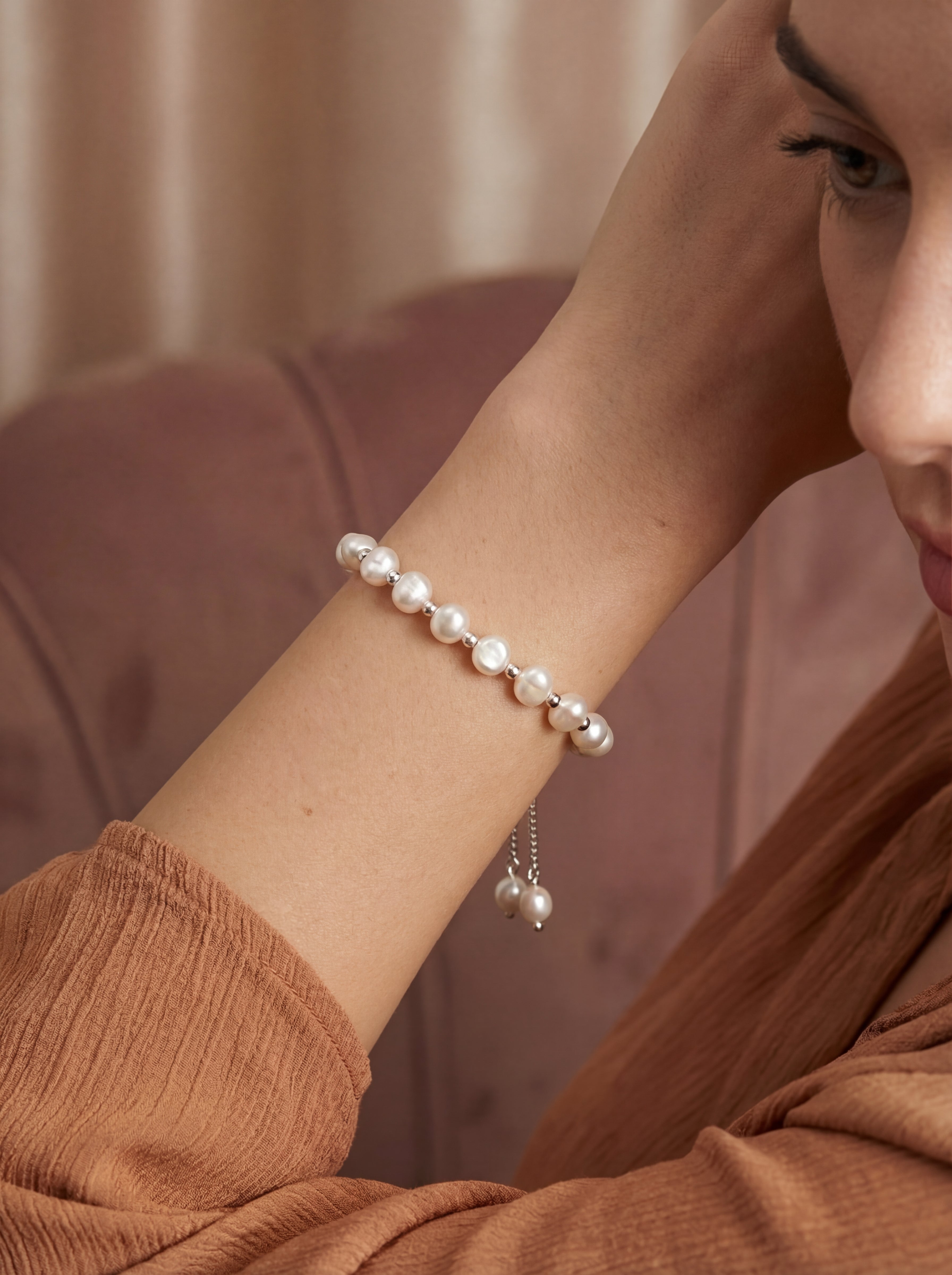 Pearl bracelet on a wrist with a blurred background